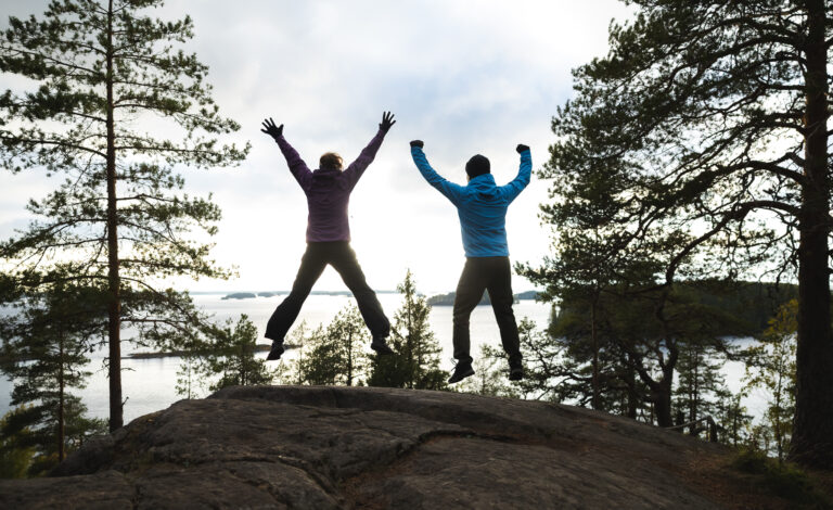 Two hikers jumping on Linnavuori viewpoint